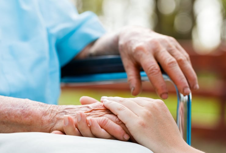 Young hand holding an elderly hand